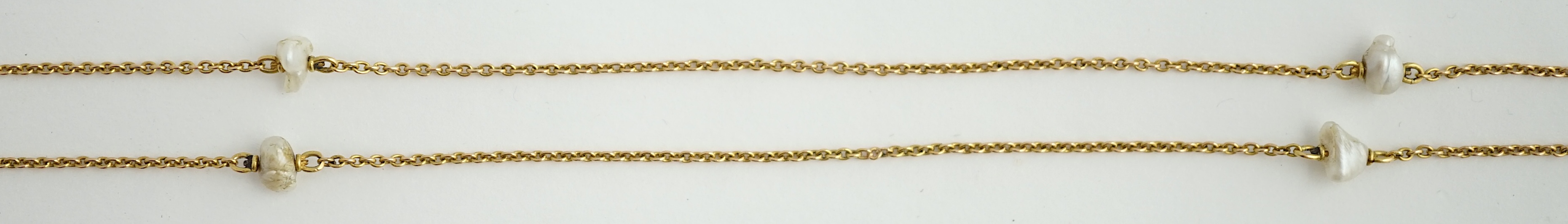 An early 20th century 15ct gold and ten stone baroque pearl set chain necklace